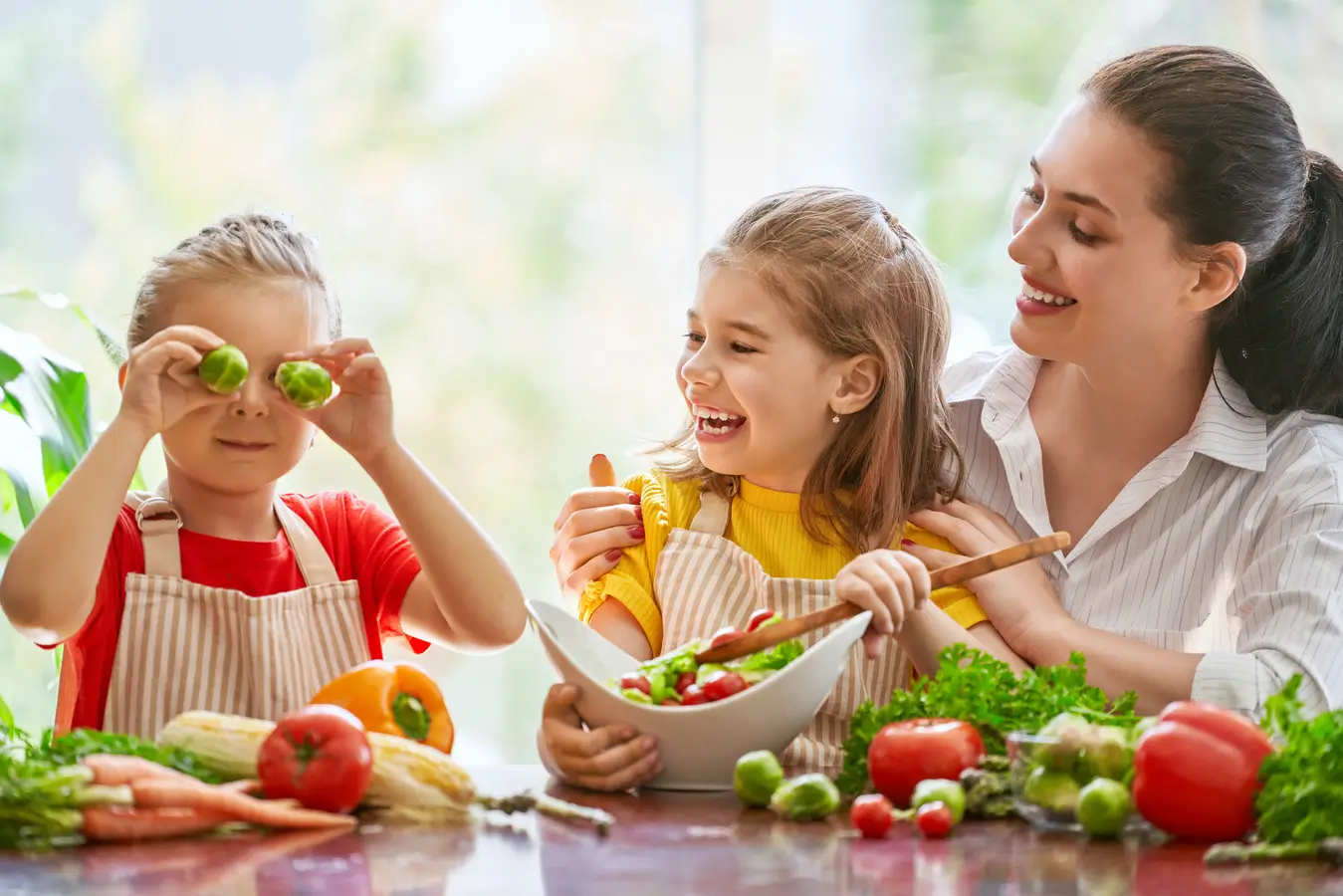 Niños disfrutando de una comida saludable con frutas y verduras